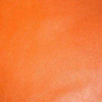 Orange leather texture with a matte finish, displaying a granular surface and subtle tonal variations, suggesting a natural grain and slight wear.